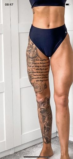 a woman with tattoos on her legs and thighs standing in front of a white wall