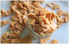 there are many pieces of food in the glass jar on the table, including tofu