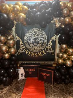 the entrance to versa nightclub is decorated with black, gold and silver balloons as well as a red carpet