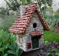 a bird house made out of rocks and stones