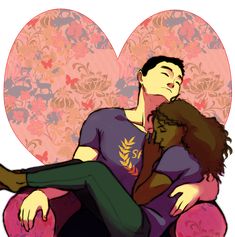 a man and woman sitting on top of a pink chair next to a heart shaped wallpaper