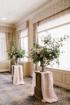 two vases filled with flowers on top of a table