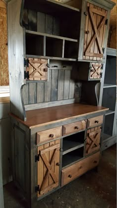 an old wooden hutch with sliding doors and drawers