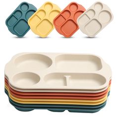 four different colored plates with compartments on each side and one in the middle for food storage