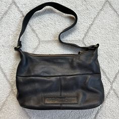 Bring a touch of early 90s/Y2K nostalgia to your style with this Fossil bag. Crafted from high-quality pebbled leather, this bag combines durability with effortless style. Features classic shoulder bag silhouette, Fossil's signature design details, and plenty of room for daily essentials. Approx 12" strap drop Tags: Early 2000s Fashion, leather handbag, retro Y2k, accessory BRAND: Fossil SIZE: Medium CONDITION: Excellent COLOR: Black FLAWS: No LINED: No Approx measurements can be found in photos or are posted in listing; measurements are taken flat. Model (if included in non-stock photos) is 5'1" typically a S, XS, 0-2 Reasonable offers welcome! Ships 1-2 Biz days! Msg with any questions! Fossil Bag, Bag Silhouette, Y2k Nostalgia, Y2k Shoulder Bag, Early 2000s Fashion, Leather Accessory, Fossil Bags, Black Pebbles, Early 90s