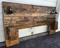 a bed made out of wooden pallets with two lights on each side and one light at the end