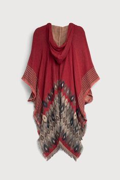 The Aztec Hooded Poncho has Aztec motifs expertly woven into the fabric, creating a visually striking piece. The poncho boasts a fringe trim that adds a touch of playful movement and bohemian charm to your ensemble, while the lurex accents woven into the fabric lend a subtle shimmer, catching the light and enhancing your look with a touch of glamour. The poncho features practical pockets and a hood featuring adjustable drawstrings. You can easily customize the fit to suit your preferences and sh Winter Cape With Tassels, Red Bohemian Hooded Poncho, Red Hooded Bohemian Poncho, Aztec Motifs, Aztec Poncho, Hooded Poncho, Fringe Trim, Suits You, Layering