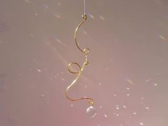 a gold wind chime hanging from a string