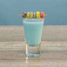 a glass filled with blue liquid and marshmallows sticking out of the top