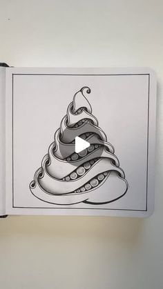 an open book with a drawing of a christmas tree on the page and a video playing below it