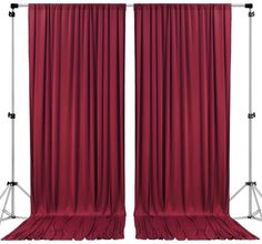 two red curtains with metal poles on them