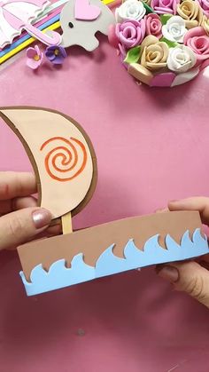 someone is making a paper boat out of cardboard