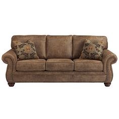 a brown couch with two pillows on it