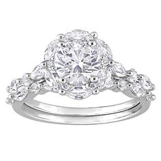 a diamond engagement ring set with three pear shaped diamonds on the band and an oval center stone