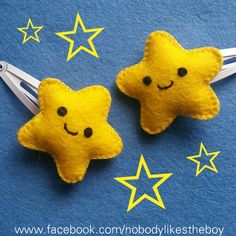 two yellow stars with faces drawn on them are sitting next to each other in the shape of scissors