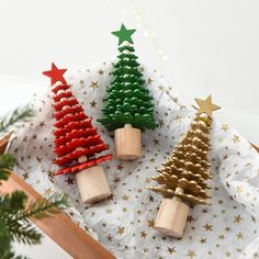 three small christmas trees are on a napkin