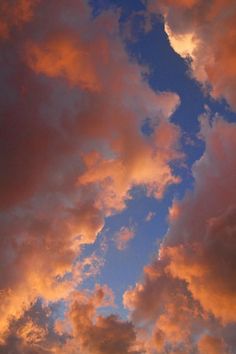 an airplane is flying in the sky at sunset or dawn with pink clouds and blue skies