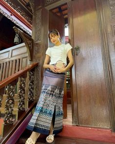 a woman standing in front of a wooden door