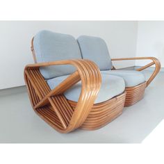 a chair that is made out of wood and has blue upholstered cushions on it