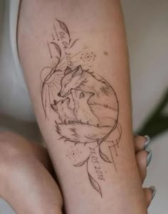 a woman's leg with a tattoo on it and a wolf in the middle