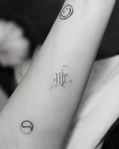 a woman's arm with the letter m on it and two circles around her wrist