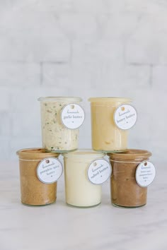 four jars of food sitting on top of a table