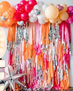 balloons and streamers are hanging on the wall in front of a starfish backdrop