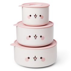 three white bowls with pink lids and faces on them