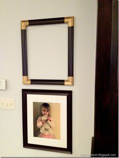 two framed pictures hang on the wall above a baby's crib and teddy bear