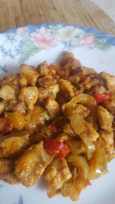 a plate with some chicken and peppers on it