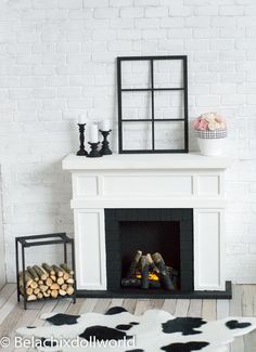 a white fireplace with black and white decor on it's mantle, next to a cow hide rug