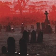 a cemetery with tombstones and red sky in the background