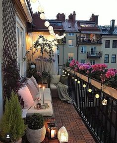 a balcony with lots of plants and lights