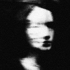 a blurry image of a man's face in black and white