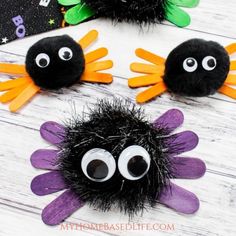 three halloween decorations made out of yarn with googly eyes and spider legs on them