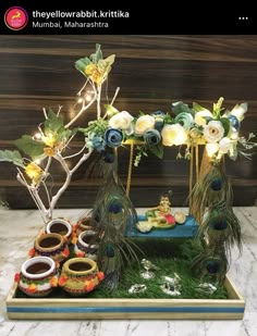 there is a decorative display with peacocks and flowers