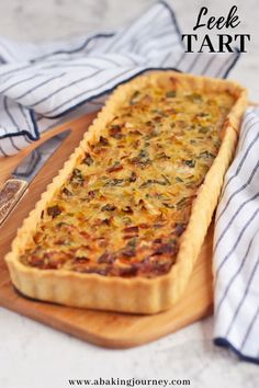 a quiche on a cutting board with the title text overlay reads leek tart