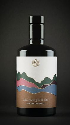 an image of a bottle of liquid on a black background that has mountains and clouds in it