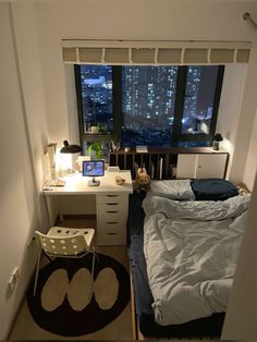 a bed room with a neatly made bed and a desk