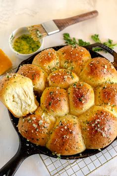 an iron garlic butter dinner rolls in a cast iron skillet