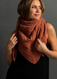 a woman wearing an orange knitted scarf