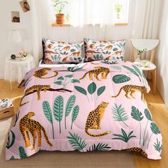 a bed with pink and green leopards on it