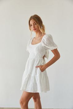 Certified sweetheart in the Hayden Puff Sleeve Babydoll Mini Dress! This darling fit and flare mini dress features puff sleeves, an open back, floral embroidery, and flowy tiered skirt. Cherry on top? This mini dress has pockets! Available in white and baby blue. Pair this summer mini dress with a chic pair of heels to complete the look! Details: 100% Polyester Tie back closure Elastic straps and waist Fully lined Two side pockets Hand wash cold Black Graduation Dress, Graduation Dress College, Pretty Maxi Dress, Wedding Event Dresses, White Babydoll Dress, Fit And Flare Mini Dress, Short Sleeve Wedding Dress, Sorority Rush, Summer Mini Dress