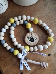 the beaded bracelets are next to a bee ornament on a table