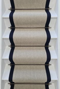 the stair treads are made from white and blue fabric with black piping on them