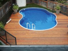 an above ground pool surrounded by wooden decking