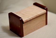 a wooden box sitting on top of a bed