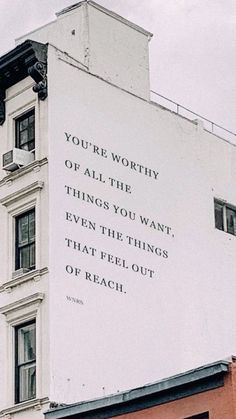 an advertisement on the side of a building that says you're worthy of all the things you want even the things that feel out of reach