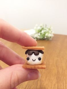 someone is holding a tiny sandwich with a smiling face on it