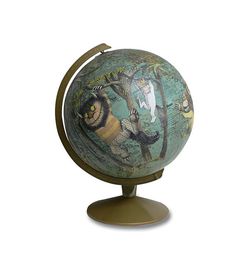 a decorative globe with animals painted on it's sides and trees around the globe